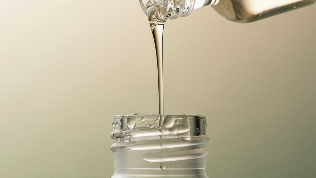 ReAwaken peptide vial pouring fresh into a base bottle